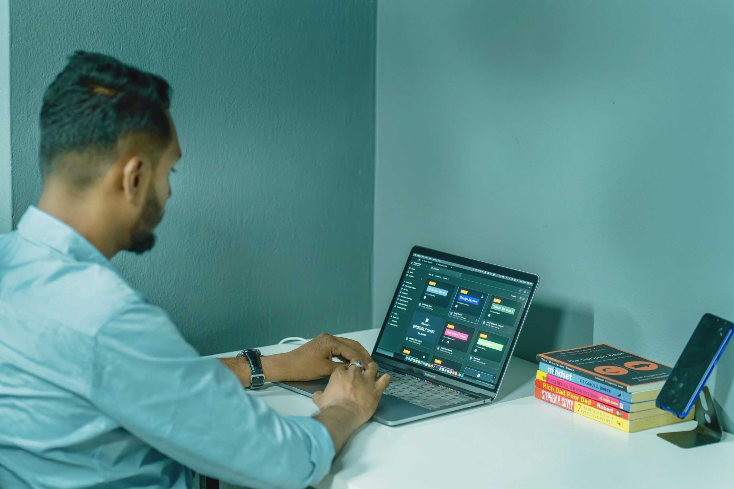 Businessman looking stressed while his phone shows error screen due to outdated software.
