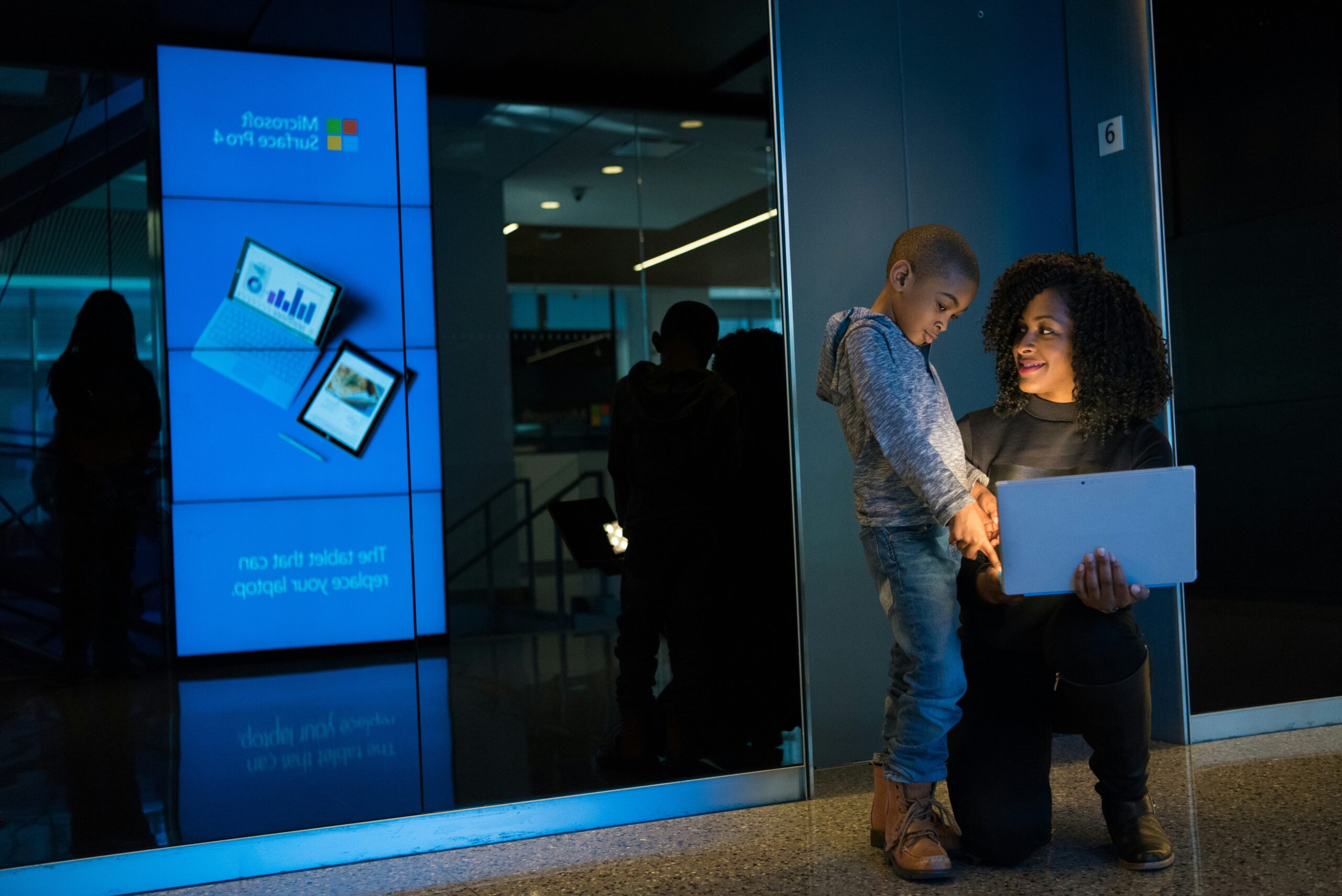 A bustling office showcasing employees using modern touchscreen phones.