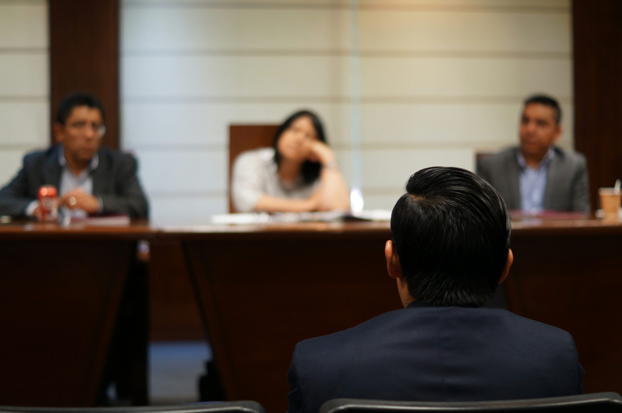 Illustration of employees sitting in a meeting receiving compliance training