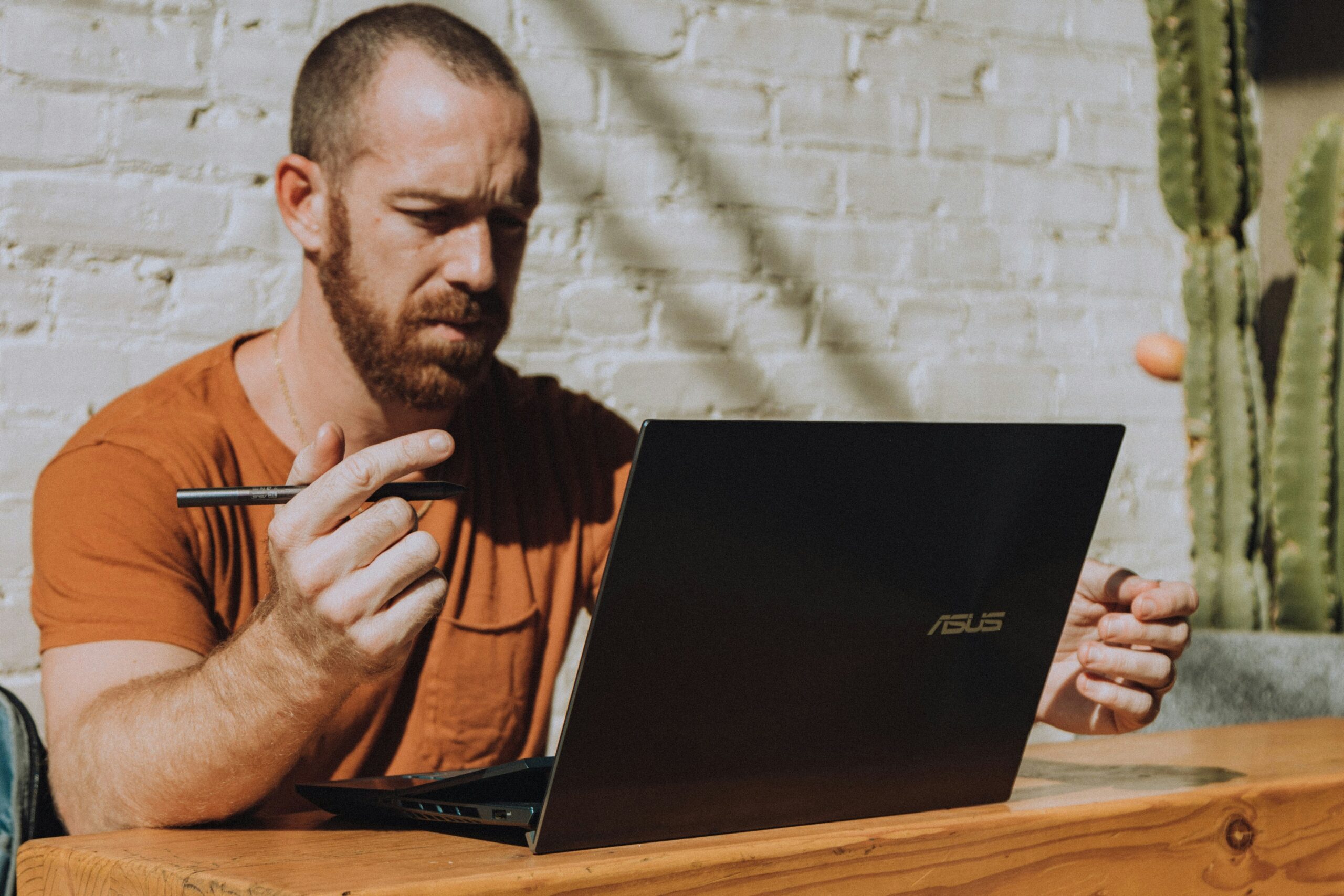 Man stressed out looking at multiple calendars on his laptop