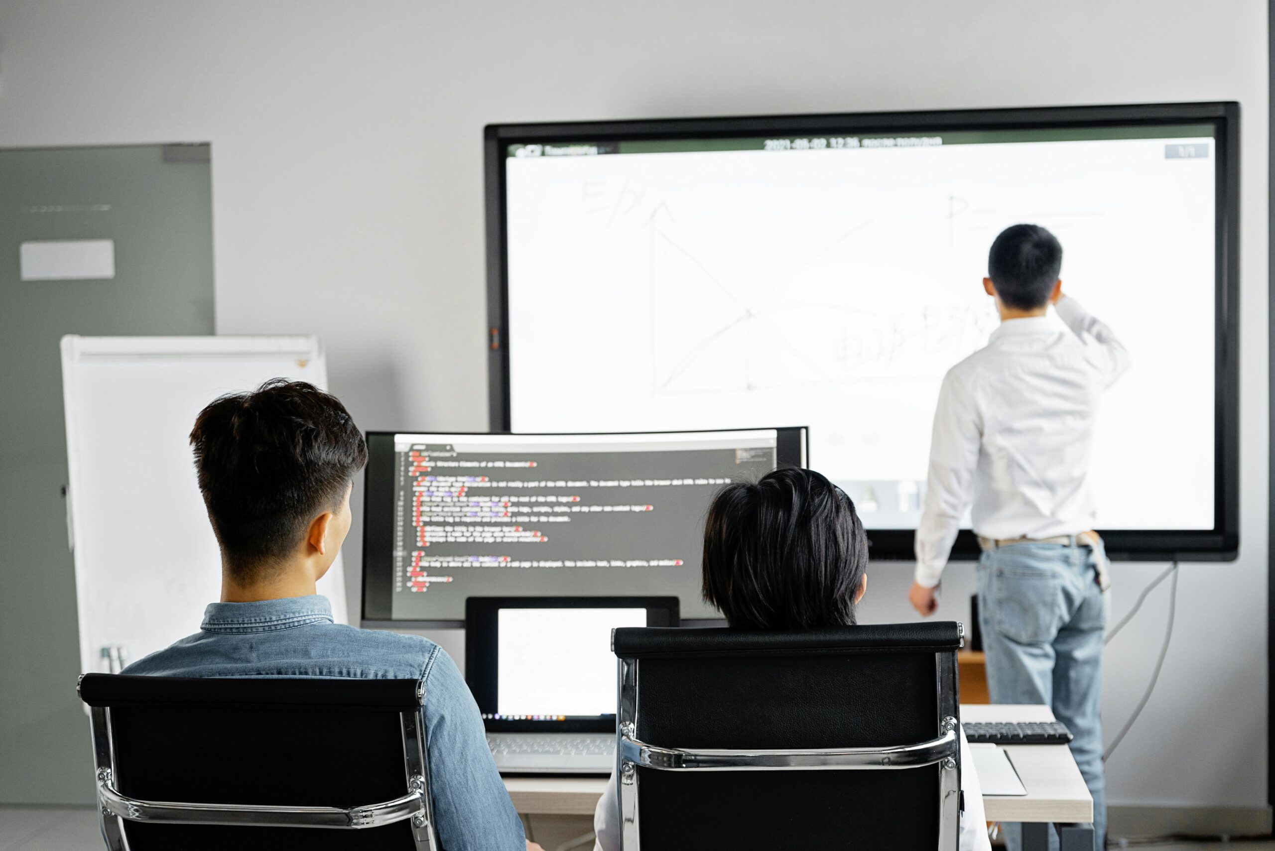 Team members gathered in an office learning about new software